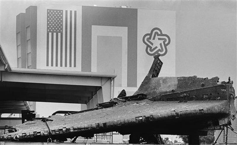 The vertical stabilizer or tail section of the Space Shuttle Challenger is seen on its side in front of the Vehicle Assembly Building, Wednesday, April 9, 1986, Kennedy Space Center. The Challenger exploded shortly after liftoff on January 28th killing seven astronauts on board. (AP Photo/Bruce Weaver)