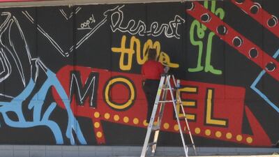 Local artist paints massive mural on Tulsa Welding School’s campus