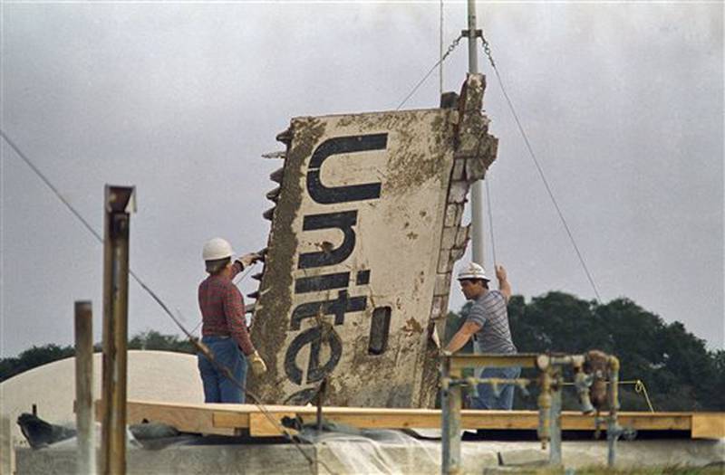 FILE - In this 1986 file photo, workers transport debris from the space shuttle Challenger, recovered after the Jan. 28, 1986 explosion, to a storage site on the Canaveral Air Force Station in Cape Canaveral, Fla. (AP Photo/James Neihouse)