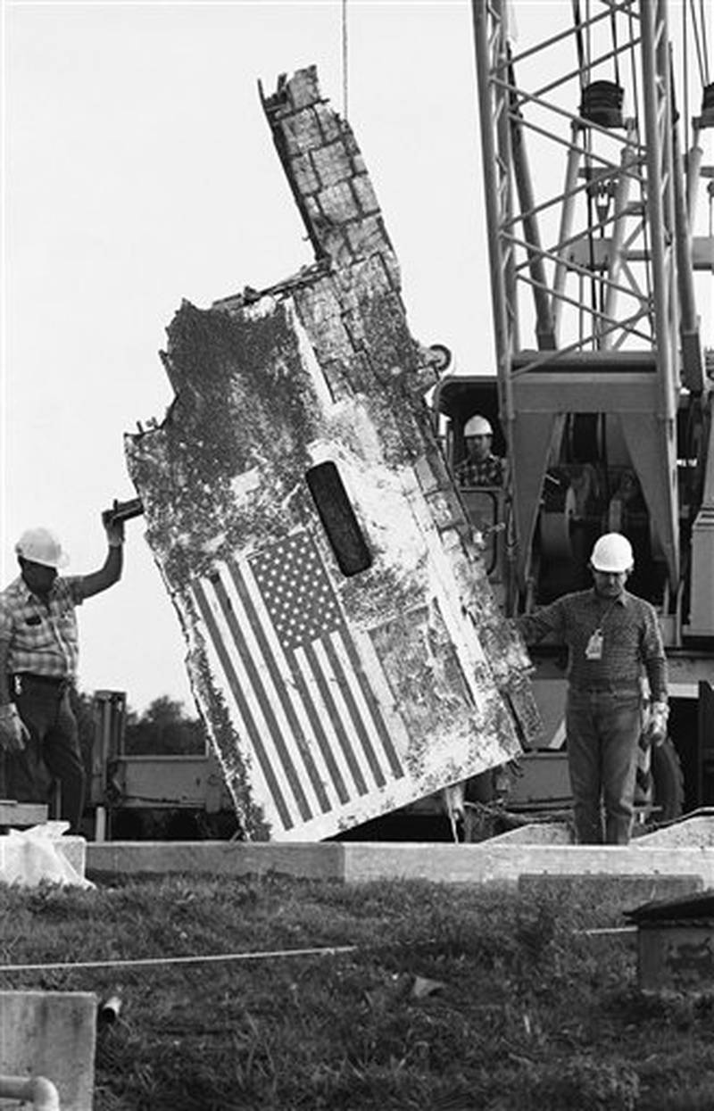 Workmen at Cape Canaveral Air Force Station, continue the process of storing the debris recovered from the Space Shuttle Challenger accident, Jan. 20, 1987, Cape Canaveral, Fla .The section being lowered into the unused Minuteman missile silo is part of the left side of the orbiter. The first anniversary of the accident will be on Wednesday of next week. (AP Photo/James Neihouse)