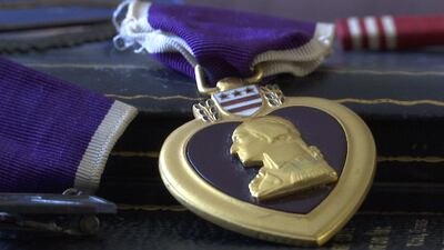Coweta man finds Purple Heart in garbage bin, reunites medal with family members