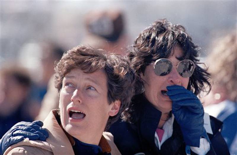 FILE - In this Jan. 28, 1986 file picture, spectators at the Kennedy Space Center in Cape Canaveral, Fla. react after they witnessed the explosion of the space shuttle Challenger. (AP Photo/File)